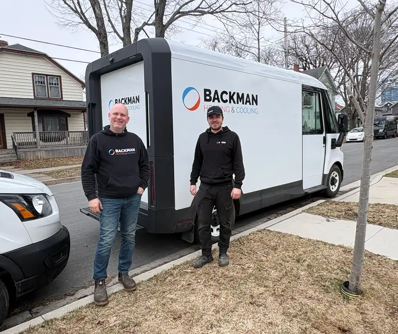 Owner Ryan Backman and team standing by their truck.
