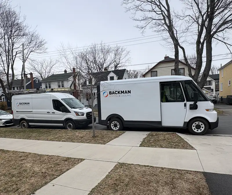 A fleet of Backman Heating & Cooling service vans.